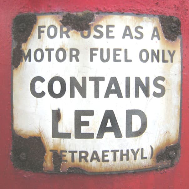 Historic fuel-pump label warning that the gasoline contains lead.
