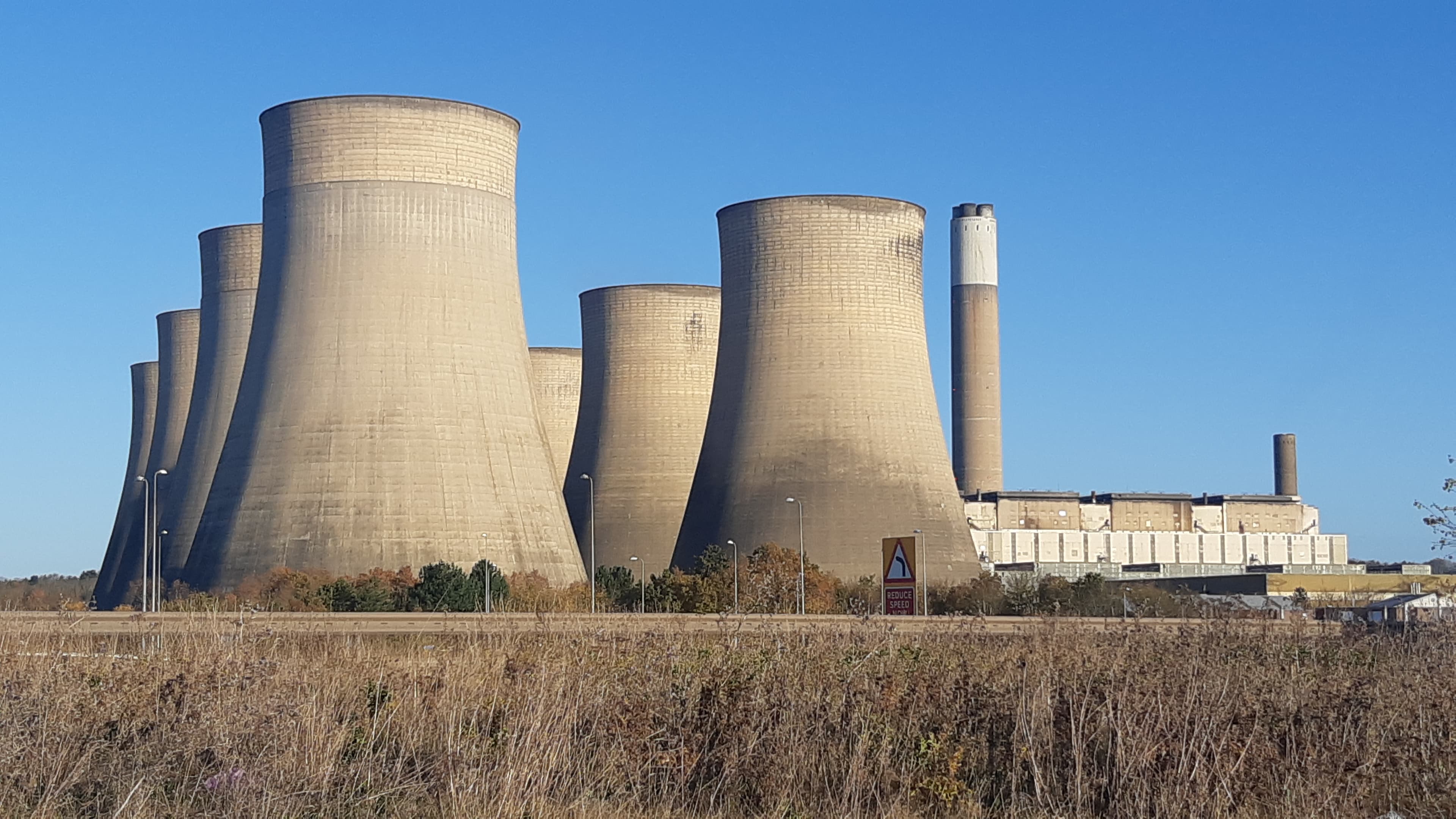 Ratcliffe-on-Soar power station and cooling towers seen across green fields.