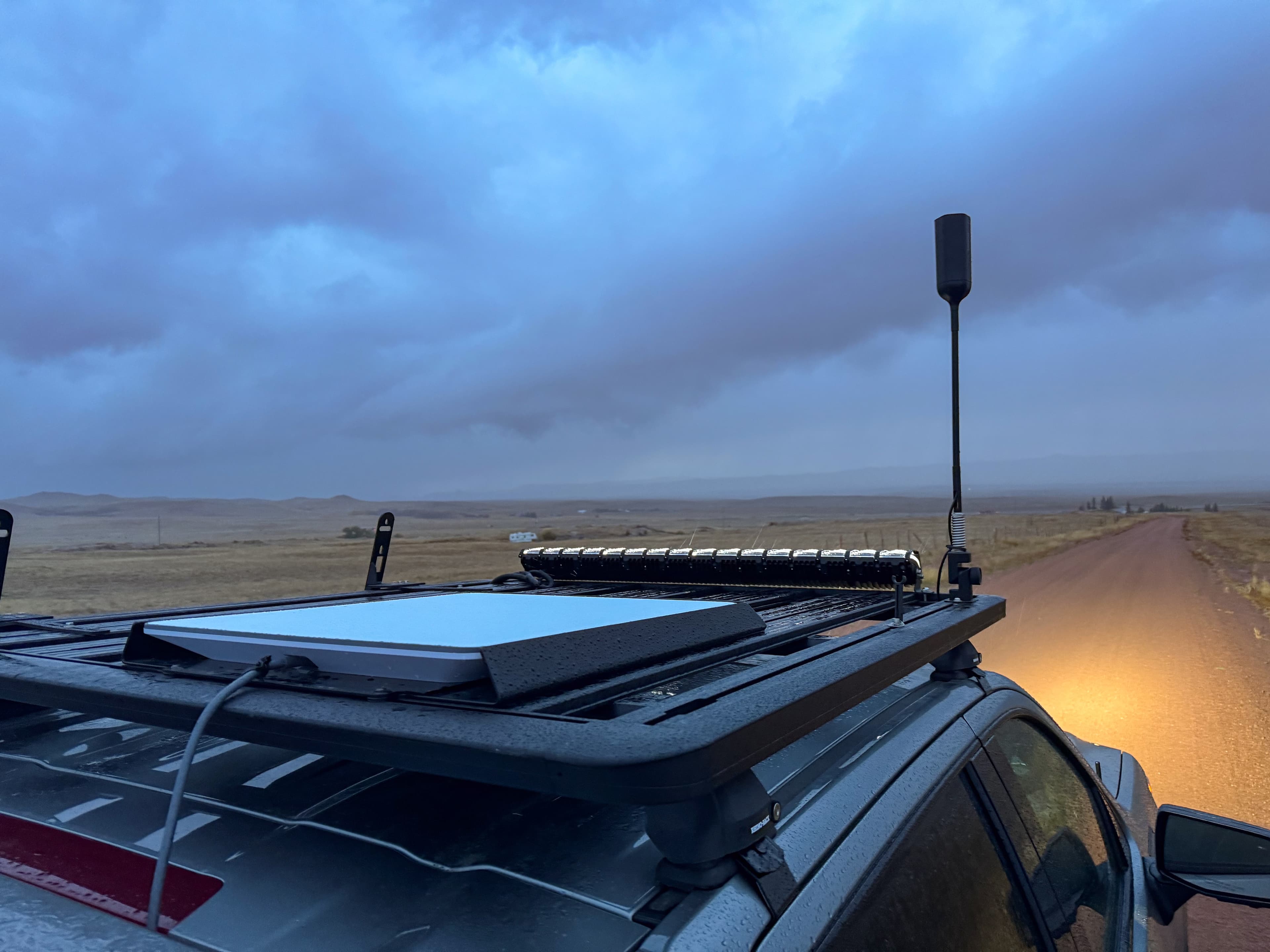 A flat Starlink terminal mounted on the roof of a vehicle